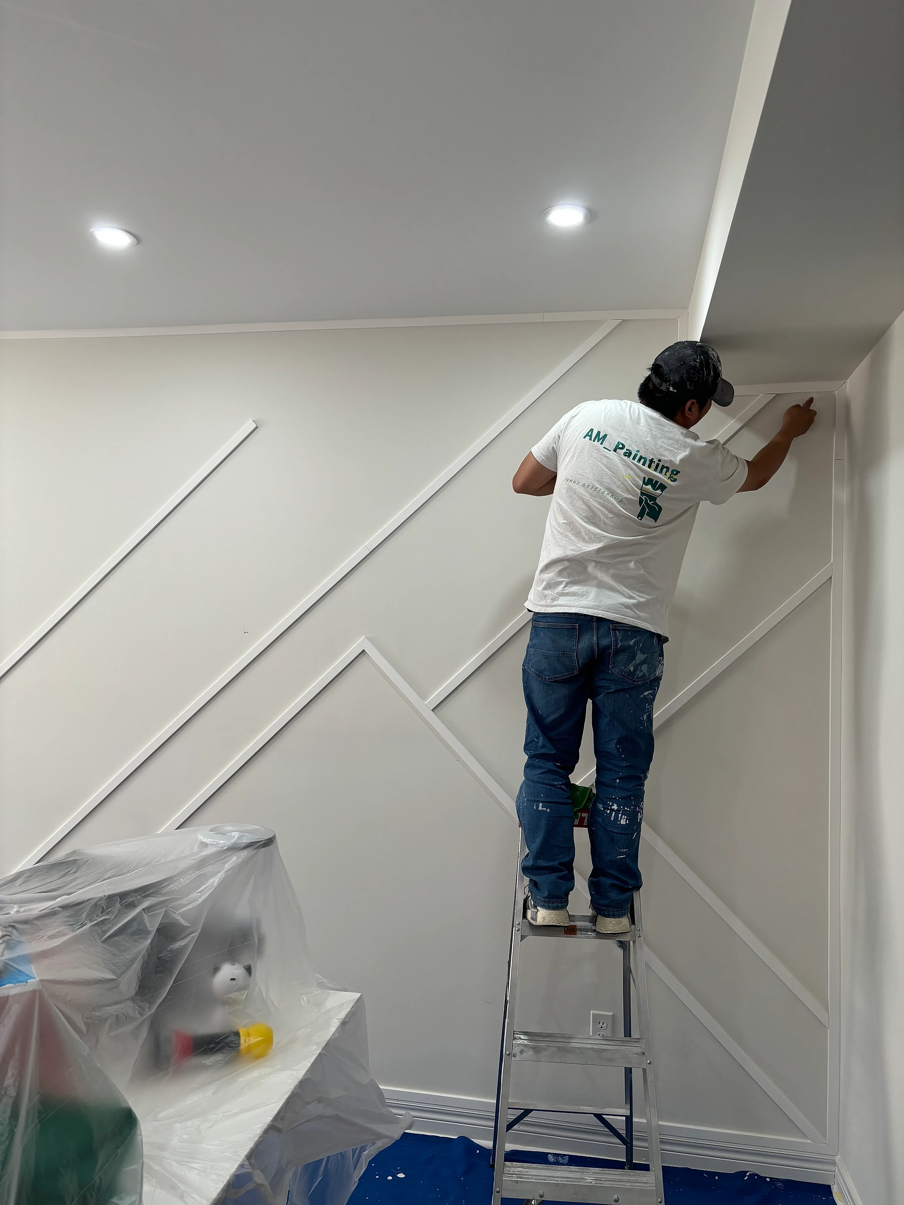 AM Painting professional carefully finishing trim on a geometric wall